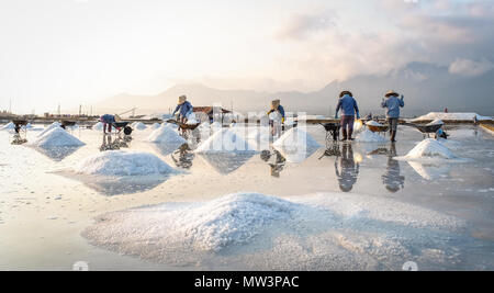 Local women working on salt field in Nha Trang, Vietnam. Stock Photo