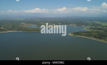 Aerial view of Paoay lake against background of mountains and sky with clouds. Paoay Lake National Park, Ilocos Norte, Philippines. Stock Photo