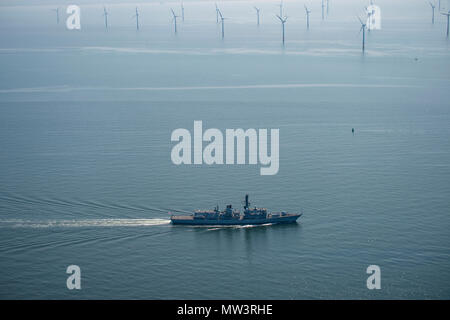 Aerial photo of Royal Navy Frigate passing wind turbines Liverpool Bay Stock Photo