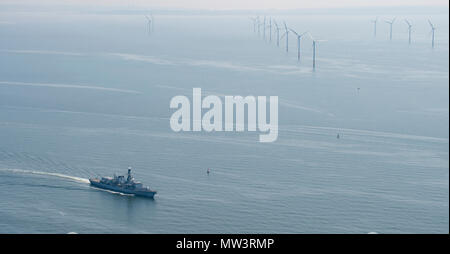 Aerial photo of Royal Navy Frigate passing wind turbines Liverpool Bay Stock Photo