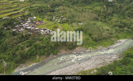 Aerial view of rice fields and agricultural land on the slopes of the mountains. Mountains covered forest, trees. Cordillera region. Luzon, Philippines. Stock Photo