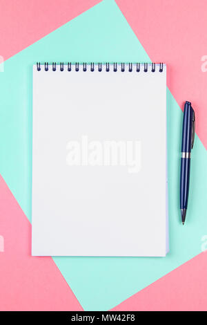 Top view flat lay picture with blank notepad page and different accessories on colored surface Stock Photo