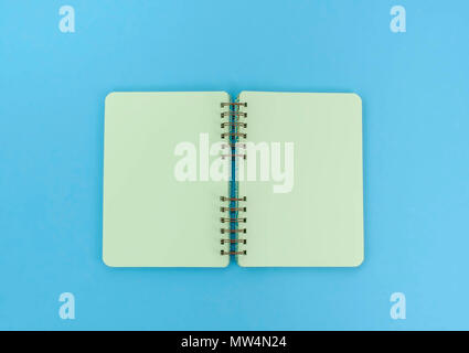Open notebook for notes is on the surface. The pastel blue background copy space Stock Photo