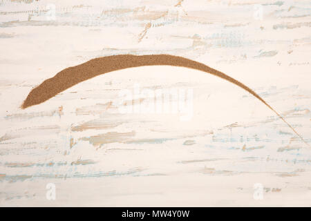 Decorative arc of golden beach sand on old textured rustic white wood with copy space Stock Photo