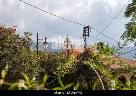 Churchtower, powerlines and bushes in Deir el Qamar, Lebanon Stock Photo