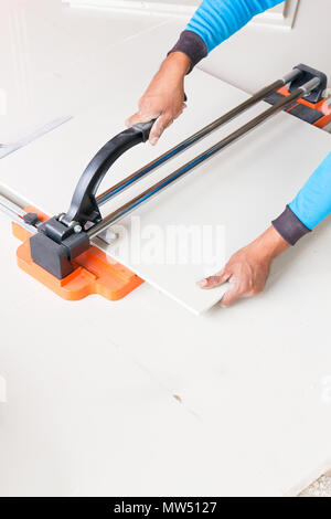Industrial tiler builder worker working with floor tile cutting equipment Stock Photo