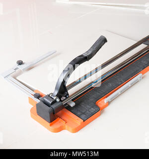 Ceramic tile cutting process using a manual cutter Stock Photo