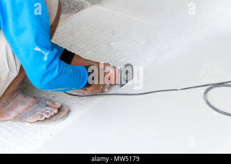 Industrial tiler builder worker working with floor tile cutting equipment Stock Photo