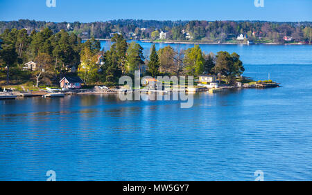 Rural Swedish landscape. Wooden houses and barns on rocky islands in sunny summer day Stock Photo
