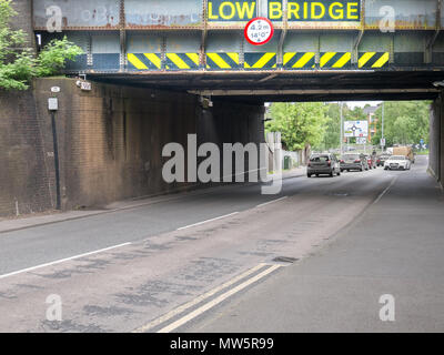 Warning to drivers of high vehicles about a low railway bridge (4.2m or 14 ft) on the A4300 Rothwell Road near the town centre of Kettering, England. Stock Photo