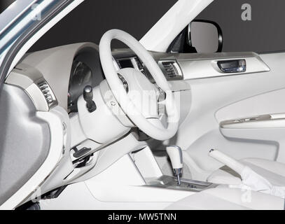 Inside look at a white leather new car interior. Very clean sleek lines and elegant design. Stock Photo