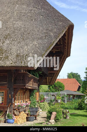 Partial view on a old historic Black forest house with front garden at Gutach village, Black Forest, Baden-Wuerttemberg, Germany, Europe Stock Photo