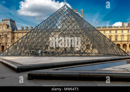 A large glass and steel pyramid serves as the main entrance to the Louvre Museum designed by Chinese American architect  I.M. Pei completed in 1989 Stock Photo