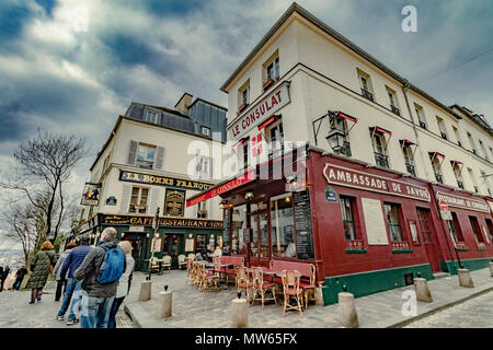 Wintertime in Paris ,tourists and visitors outside Le Consulat ,a popular restaurant and Café in Montmartre ,Paris ,France Stock Photo