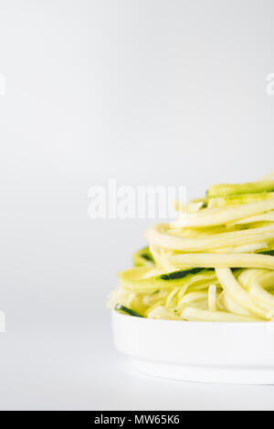 Spiralised Zucchini against White Background with Space for Copy. Stock Photo