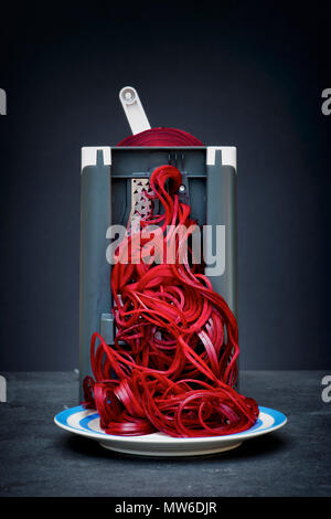 Spiralizing beetroot against a dark background Stock Photo