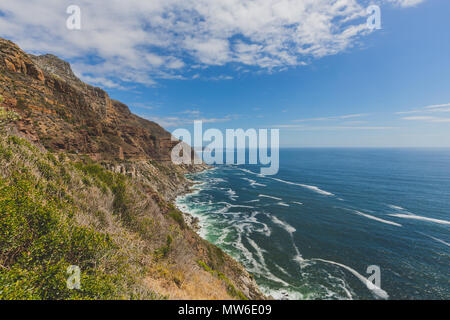 Chapman's Peak Drive along rocky coastal landscape in Cape Town Stock Photo