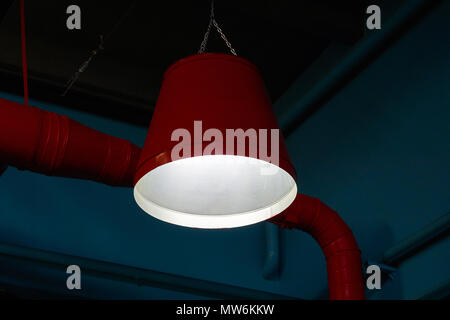 Industrial style electric lamp on dark blue background Stock Photo