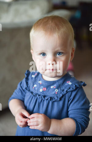 Female toddler blonde hair wearing a cream knitted hat and a pink ...