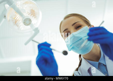 Attractive stomatologist wearing sterile uniform Stock Photo