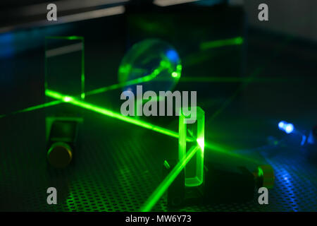 Green laser on optical table in a quantum optics laboratory Stock Photo