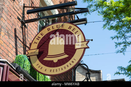 An exterior mounted pub sign for the pub and restaurant The Blue Bell in Warrington Cheshire May 2018 Stock Photo