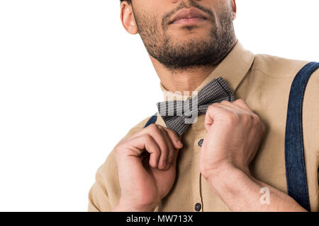 Cropped shot of stylish bearded man adjusting bow tie isolated on white Stock Photo