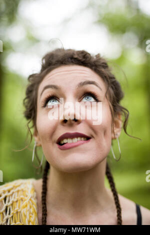 Portrait of young woman makes facial gesture Stock Photo