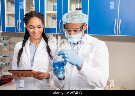 Two medical workers analyzing test tube in laboratory Stock Photo