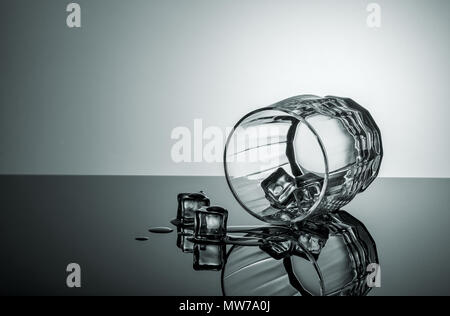 Lying glass with ice cubes Stock Photo