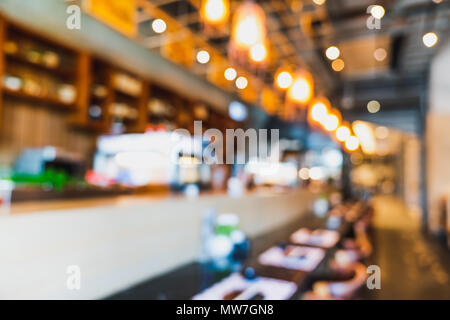 Blurred, defocused background of modern Japanese restaurant's empty counter bar with bokeh lights. Food and drink industry, coffee shop or cafe Stock Photo