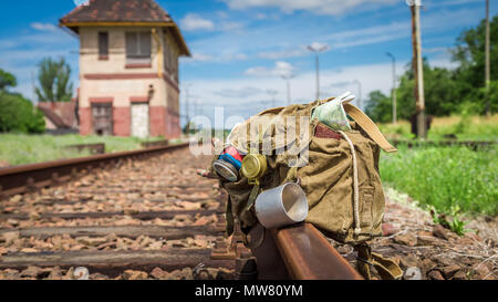 Backpack with map, compass and diary on train tracks Stock Photo