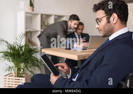 selective focus of disabled african american businessman using tablet in office Stock Photo