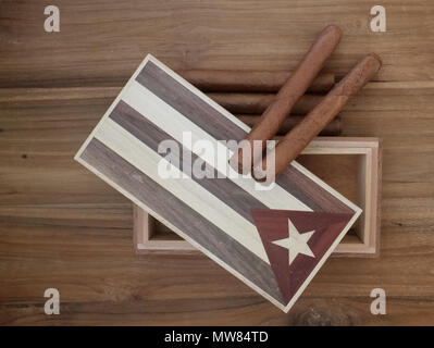 Studio scene of Cuban cigars and vintage cigar box on old wooden table. Stock Photo