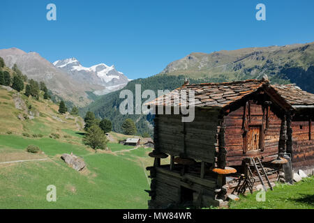 Image shows typical old Swiss wooden huts with view on Monterosa massif in the background, Wednesday 24 August 2016, near Zermatt, Switzerland. Stock Photo