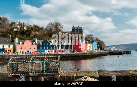 Fishing trap on a quay wall with the colorful town of Tobermory in the background Stock Photo