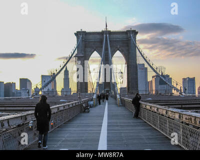 Brooklyn, New York, United States - 30th April, 2008: people walk on the famous Brooklyn Bridge at sunset. Stock Photo
