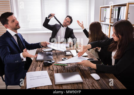 Group Of Frustrated Young Businesspeople Having Discussion In Meeting Stock Photo
