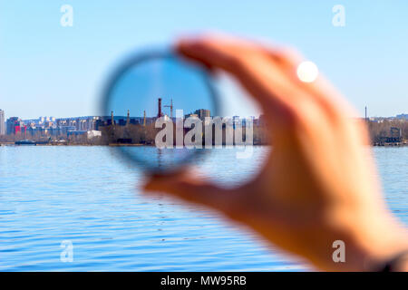City through a polarizing filter in the female hand Stock Photo