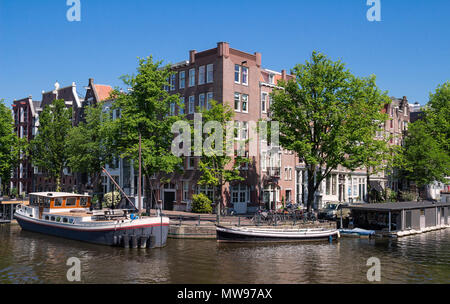 Beautiful landscape with medieval houses and boats on the canal in Amsterdam. Stock Photo