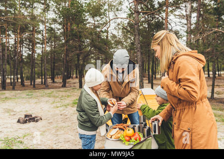 happy family having picnic on nature on cold autumn day Stock Photo