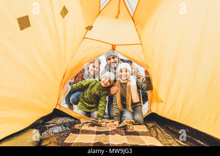 view from camping tent on family looking at it Stock Photo
