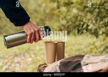 Selective Focus Shot Of A Hand Pouring Water From A Thermos In Calabash Mate  Cup With Straw Stock Photo - Download Image Now - iStock