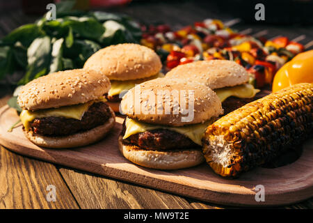 Hot delicious burgers and vegetables grilled for outdoors barbecue Stock Photo