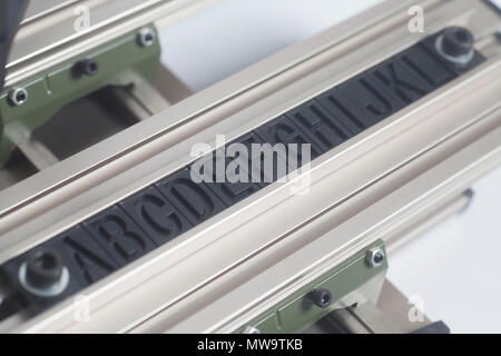 Engraving device pantograph with letterpress alphabet on a white background Stock Photo