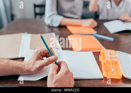 close-up shot of man holding pencil in hands Stock Photo