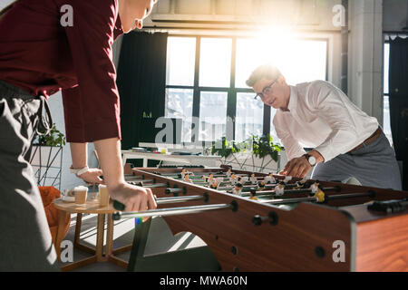 happy business people playing table football at modern office Stock Photo