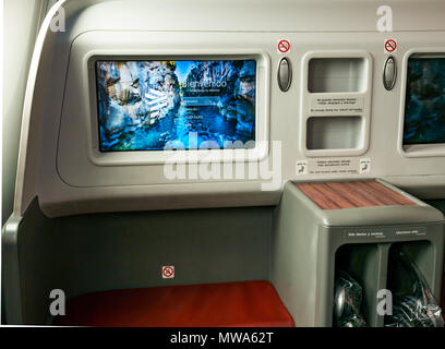 Business Class seats LATAM airlines Dreamliner 787 flying from Easter Island to Santiago, with welcome video console in flight entertainment Stock Photo