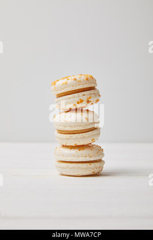 closeup shot of stack of macaroons on white wooden table Stock Photo