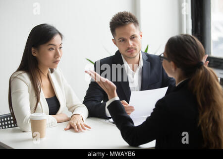 Skeptical diverse hr managers interviewing female applicant, bad Stock Photo